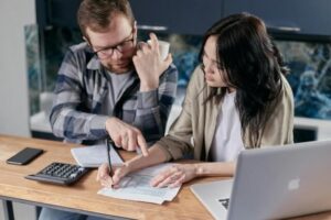 Man and woman at desk discussing their company's technical debt