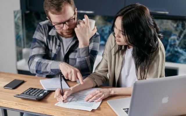 Man and woman at desk discussing their company's technical debt